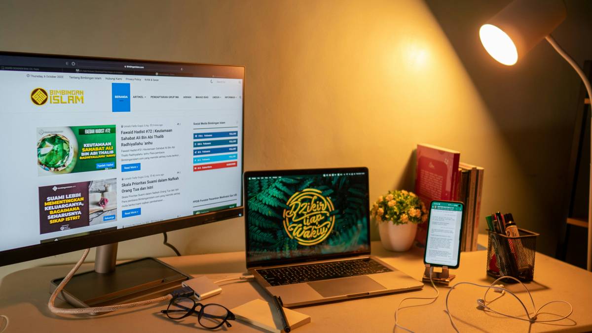 Two laptops side by side comparing different data research software interfaces.