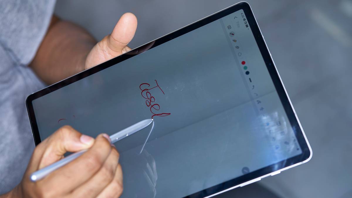 A group of colleagues discussing around a laptop displaying a citation organizer app